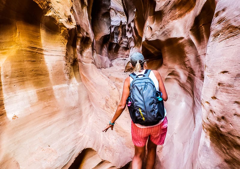 woman walking through peekaboo Slot Canyons, Utah