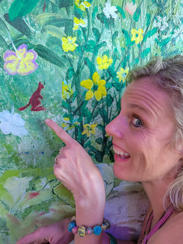 woman looking at a painting on a wall