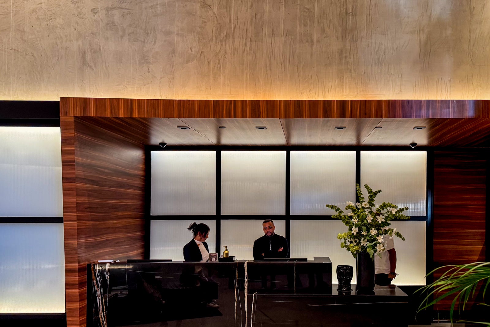 two people standing at hotel desk