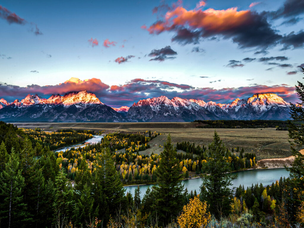 view of snake river and grand tetons at sunset from snake river overlook