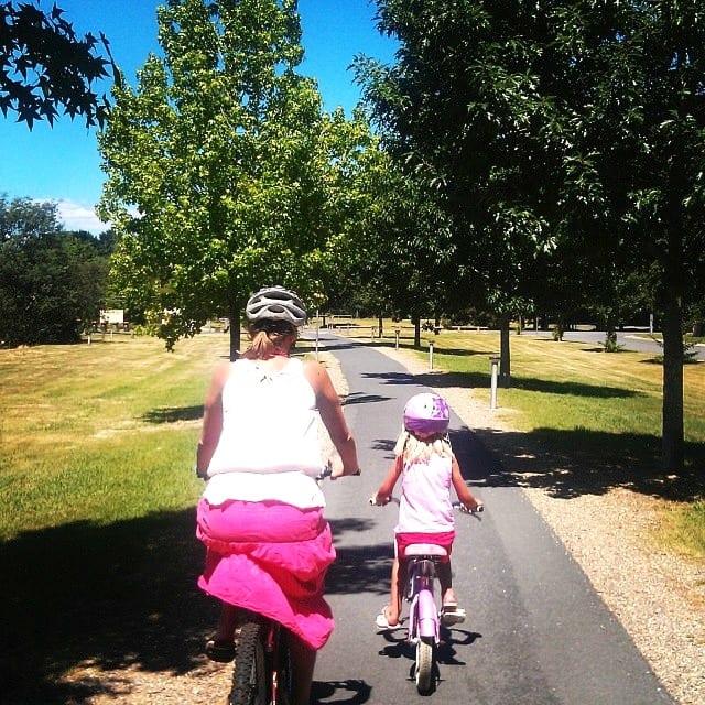 mother and child biking a trail in bright