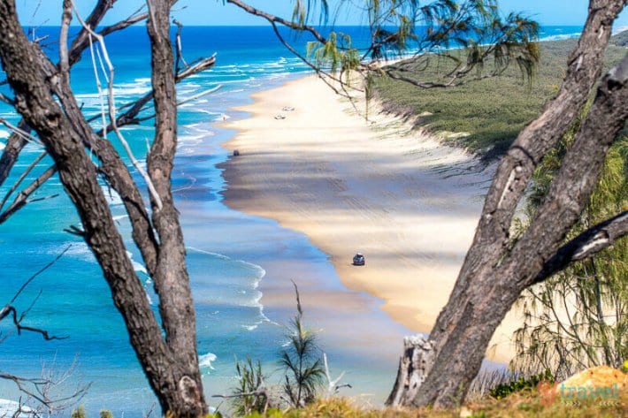 aeiral view of 4wd on driving on 75 Mile Beach -