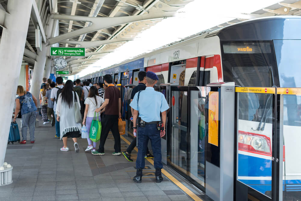 people getting on the BTS sky train in bangkok
