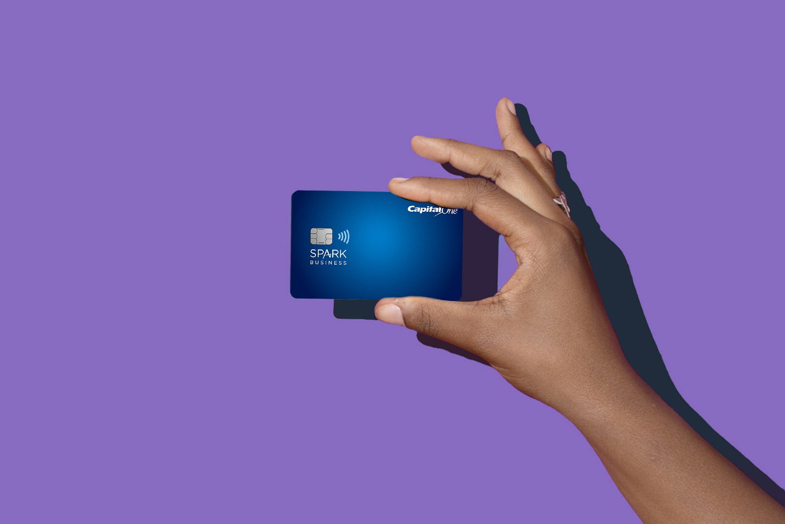 a hand holds a credit card