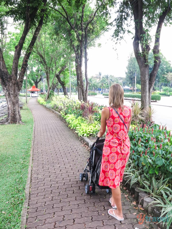 woman pushing pram in Lumphini park