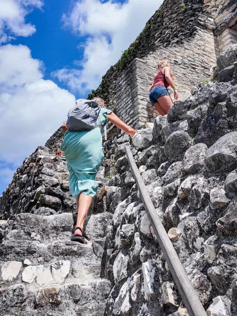 people walking up narrow stairs of el castillo