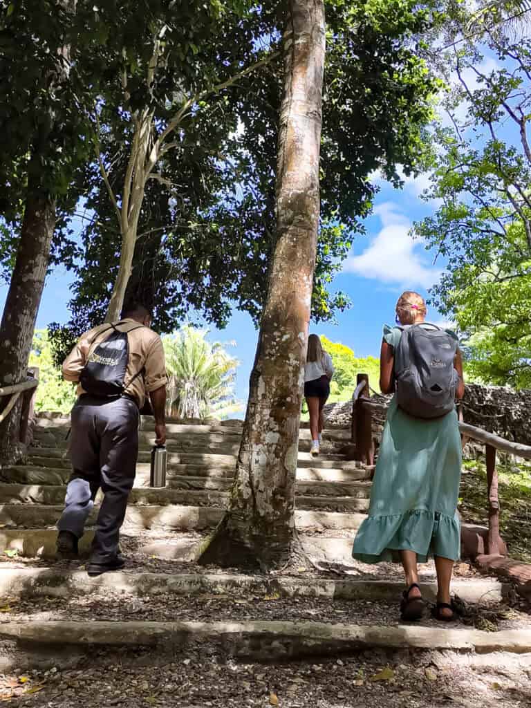 man and woman walking up stairs to Xunantunich 