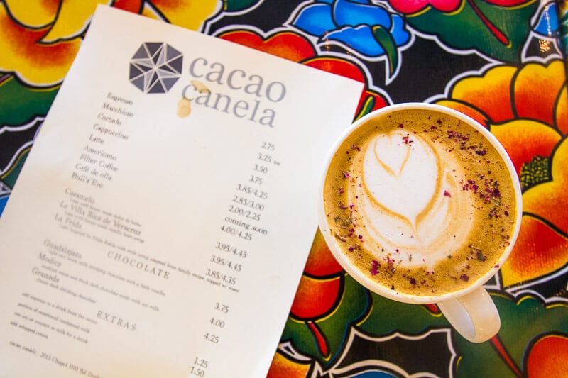 coffee beside menu on table at at Cocoa Cinnamon Cafe in Durham, North Carolina