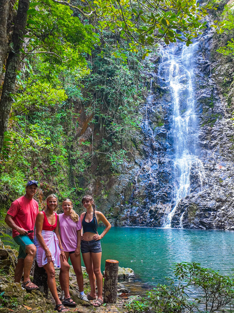 family posing in front of butterfly falls belize