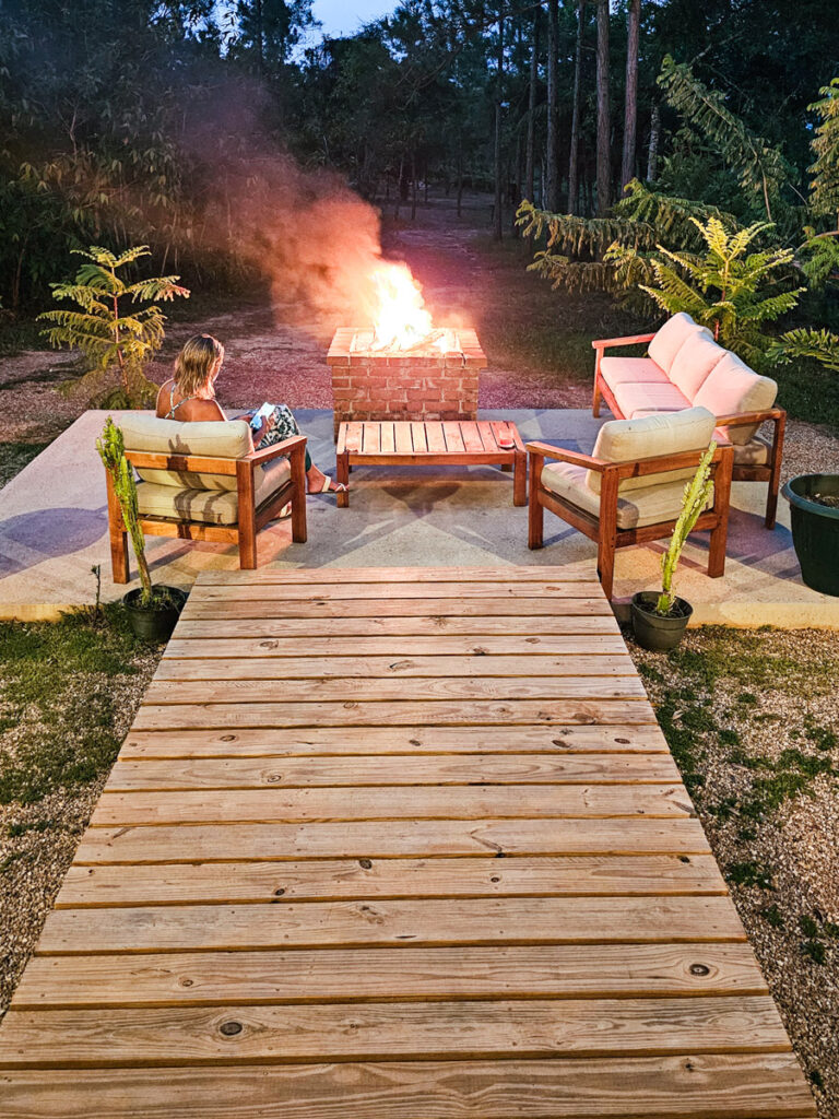 woman sitting around firepit outside slate restuarant