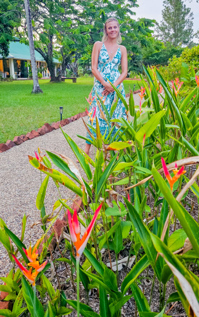 woman next to birds of paradise gardens