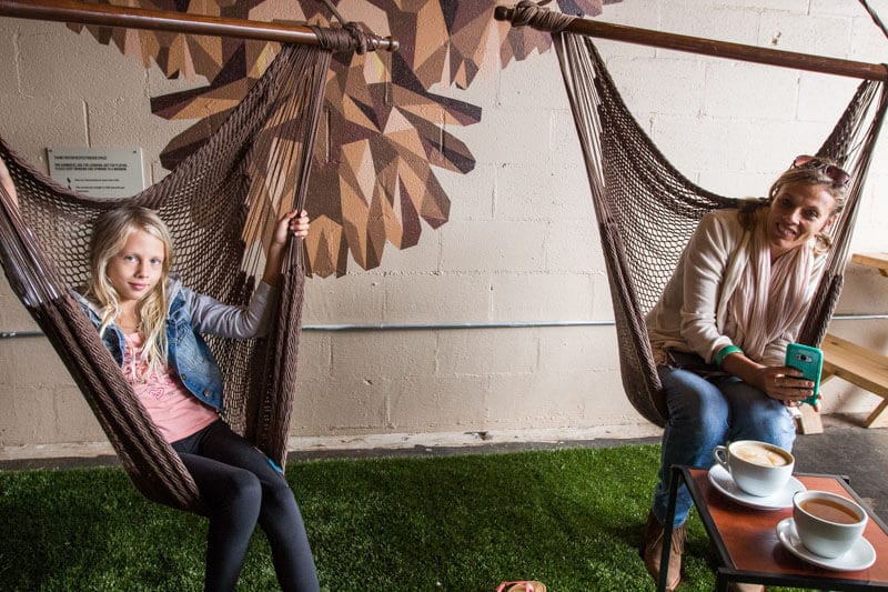 woman andgirl sitting on hammocks with coffee on table K Brew Cafe, Knoxville, Tennessee