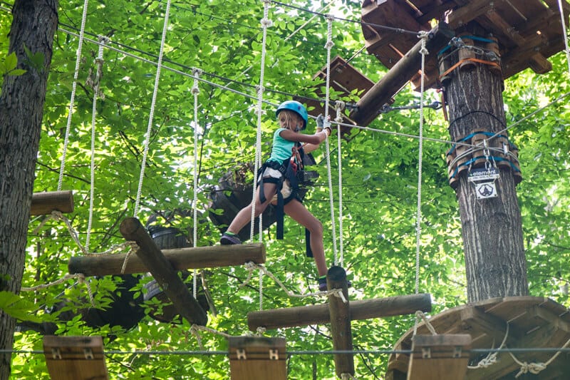 girl on a obstacle course in the trees