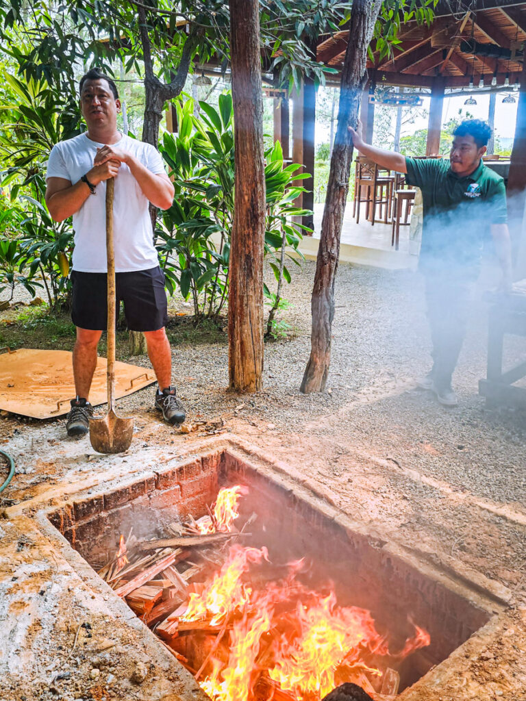 Chef Sean Kuylen prepares roasting underground pit