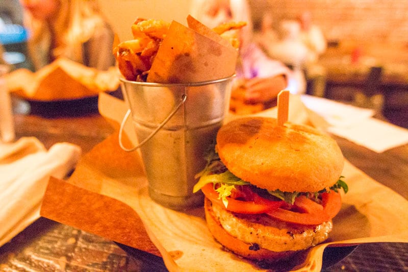 burger and bucket of fries on plate Stock & Barrel