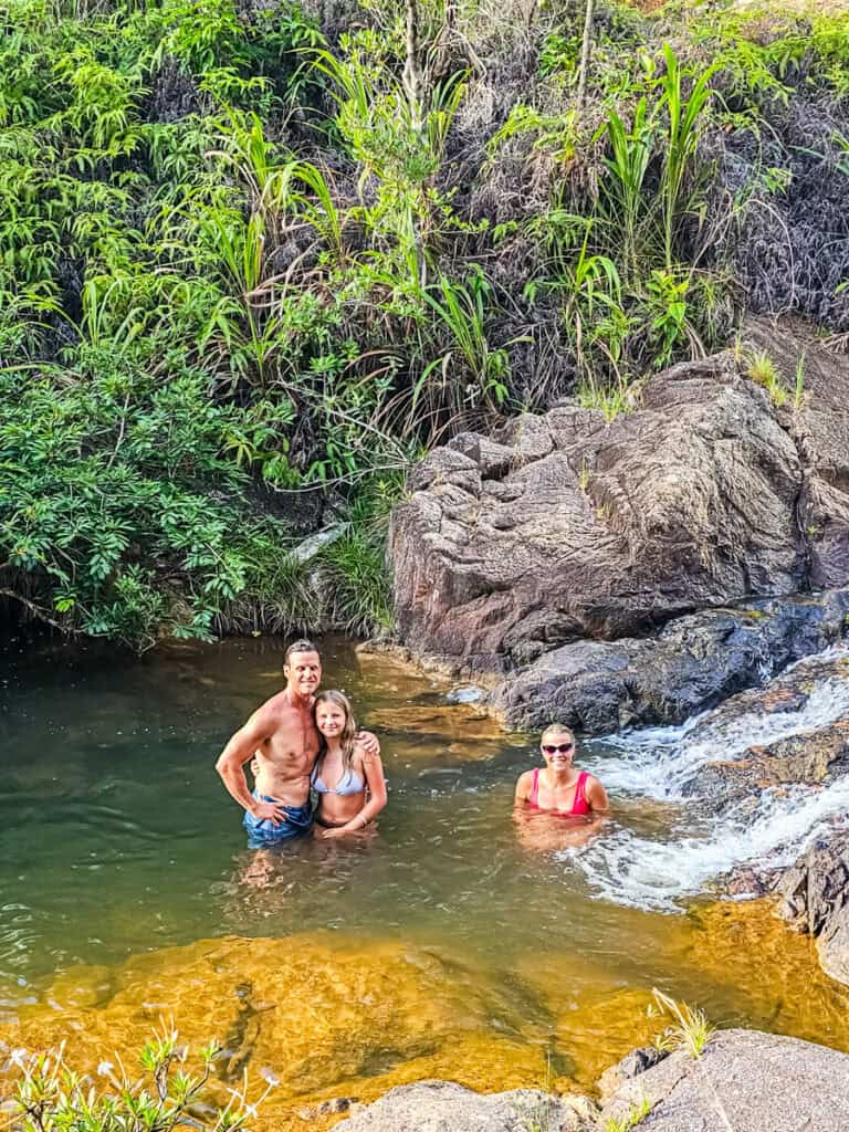 family swimming in tiger creek falls pools