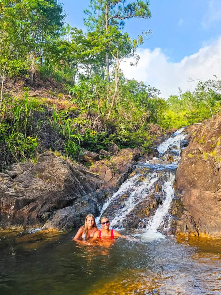 woman and child at base of waterfall