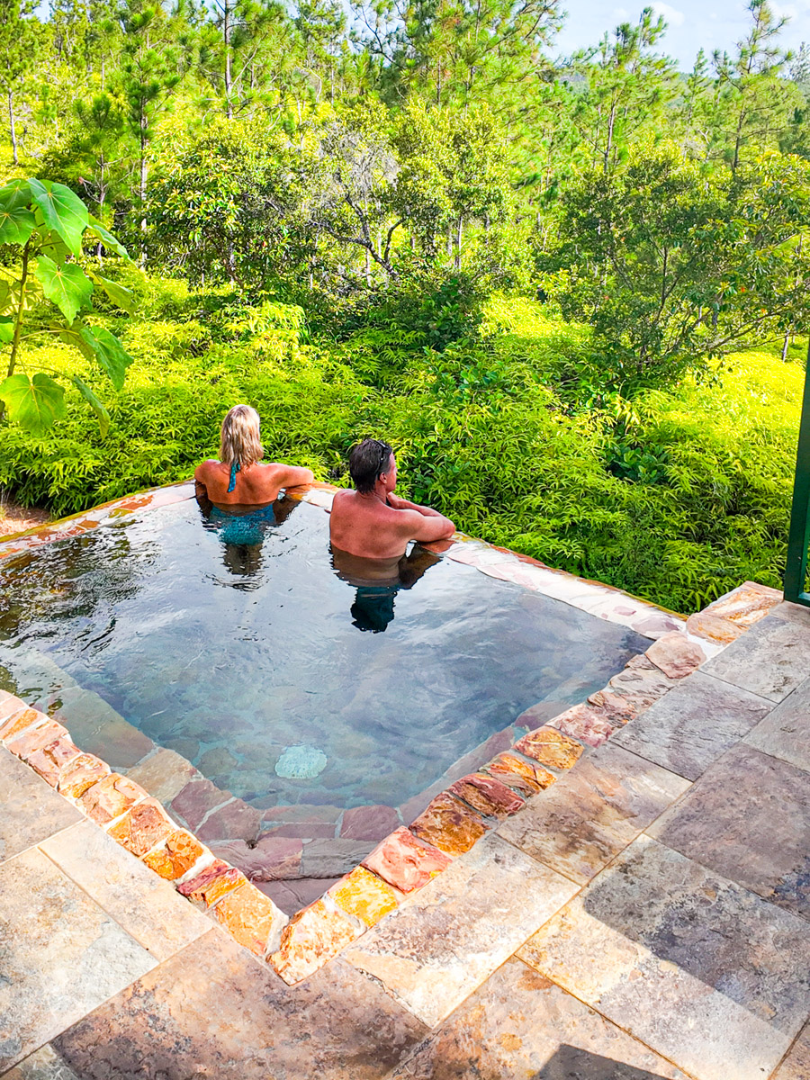 couple in private villa plunge pool looking at view